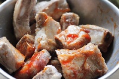 Cho vào chén sườn một muỗng canh sốt cà chua, nửa muỗng cà phê muối và nữa muỗng cà phê tỏi băm, trộn đều, ướp khoảng 2 tiếng.