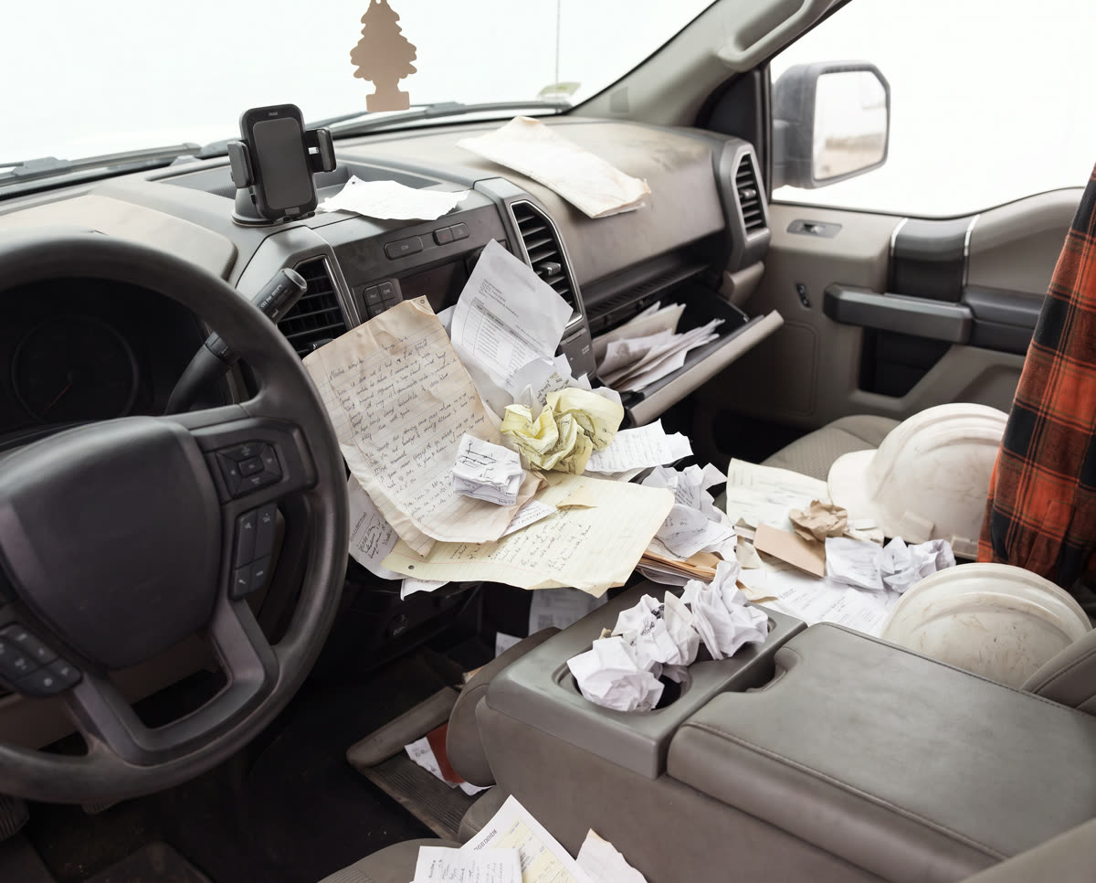 Truck dashboard buried in crumpled notes