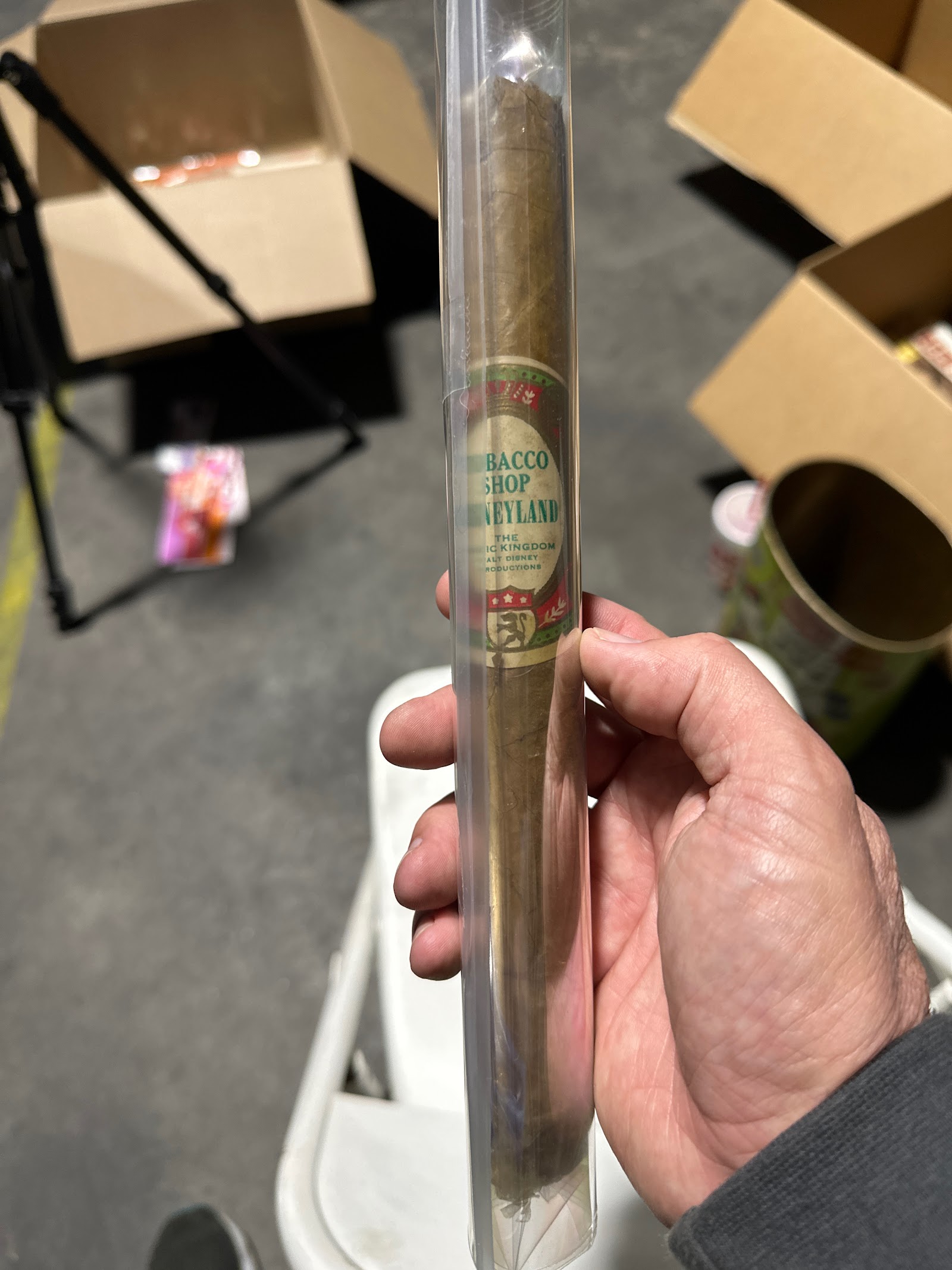 Disneyland Magic Kingdom branded tobacco cigar in clear plastic tube with brown, cream, green, red, and gold label, circa 1970s–1980s
