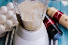 Bật lò nướng trước 10 phút ở 177 độ C. Chế 1 hộp sữa đặc (condensed milk), 1 hộp sữa cô đặc (evaporated milk) vào máy xay sinh tố, tách 6 quả trứng gà vào cùng, thêm 2 muỗng tinh chất vani, 2 muỗng bột cà phê. Bật máy xay cho trứng và các nguyên liệu hòa quyện vào nhau.