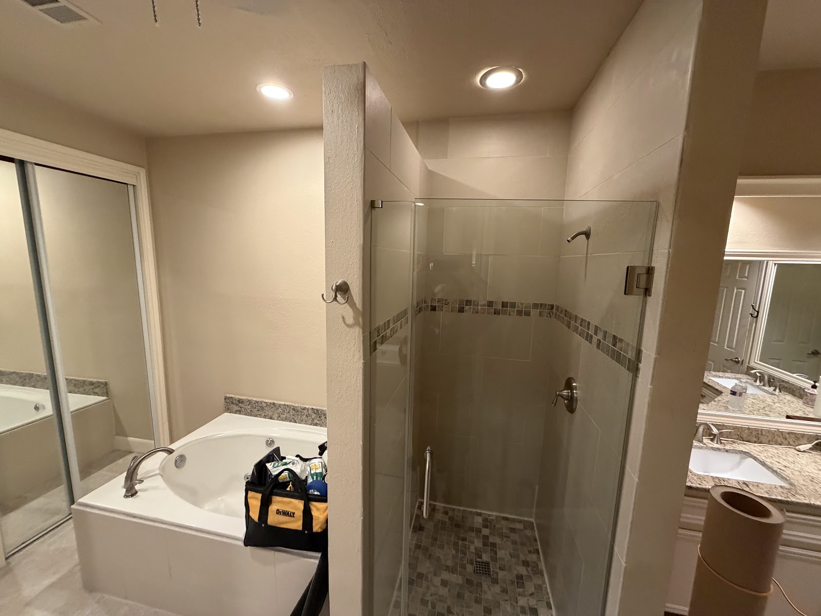 Before shower installation — dated Houston bathroom with garden tub and small framed shower