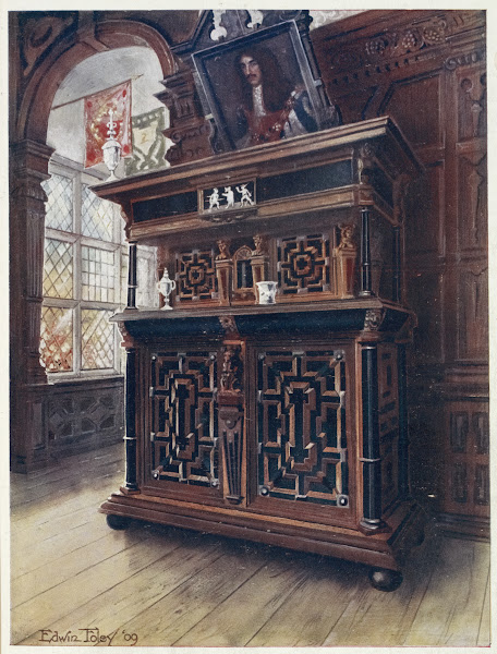 A cabinet of oak and walnut with ebony panels and columns inlaid with rosewood a