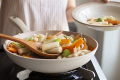 Múc Tteok ra dĩa và gắp thịt bò đã xào để lên trên.