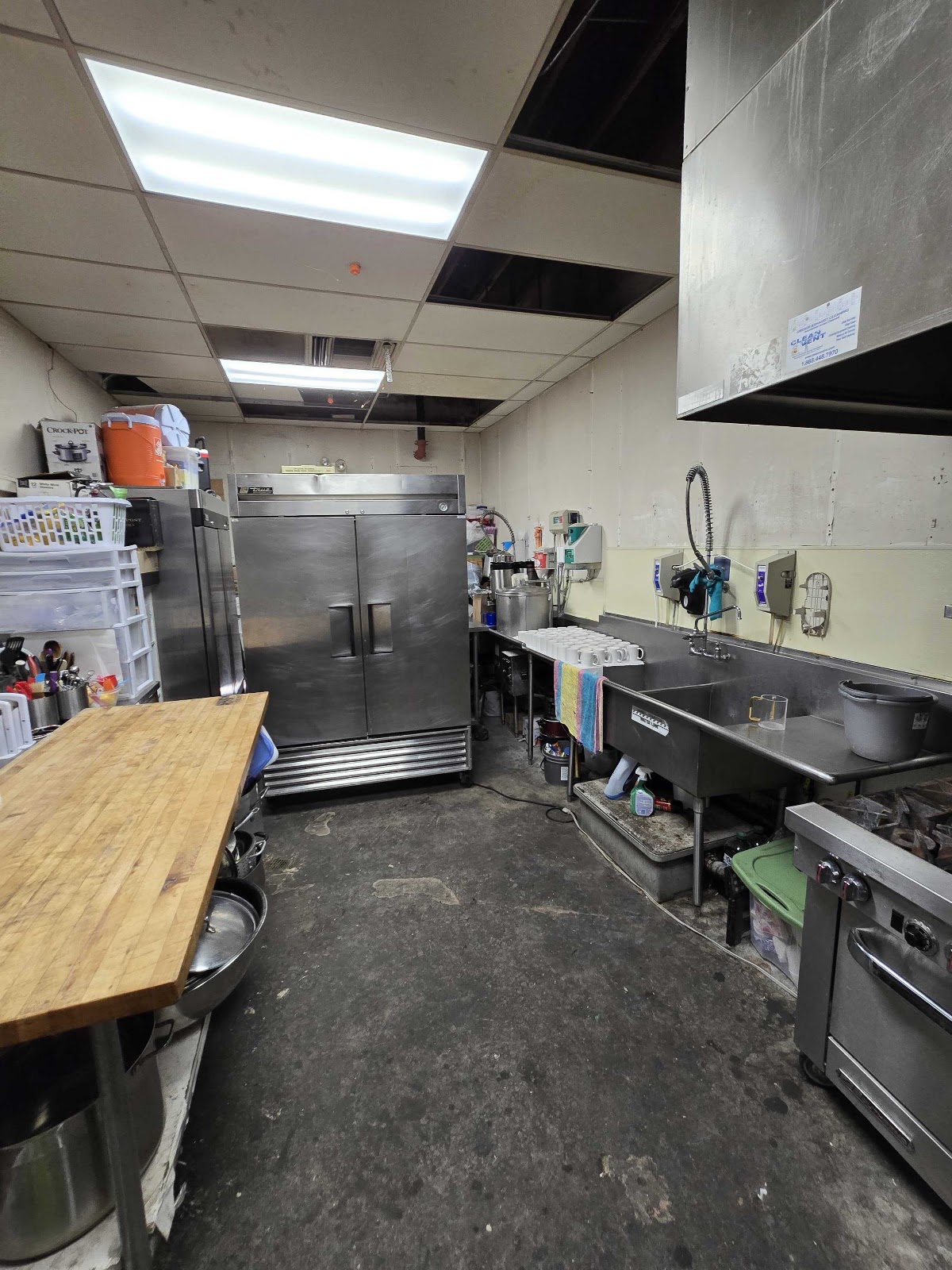 Commercial kitchen equipment wall — completed ceiling