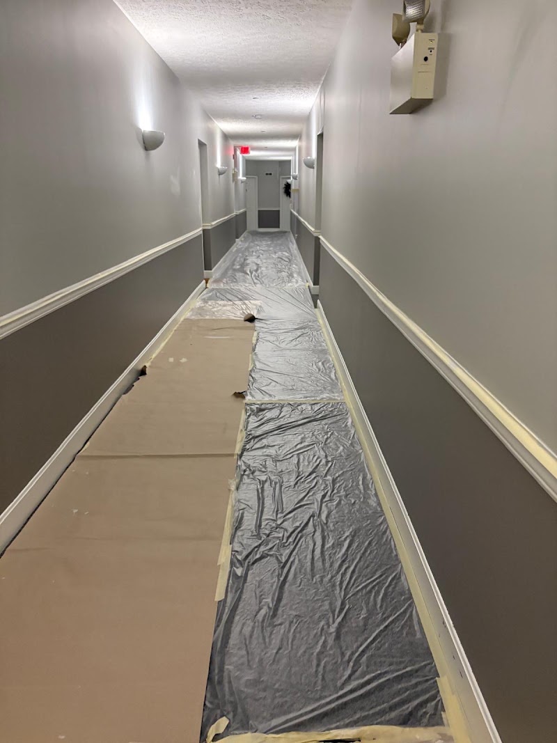 Yardley Court hallway repaint in progress, floor protection down and new wall color going up