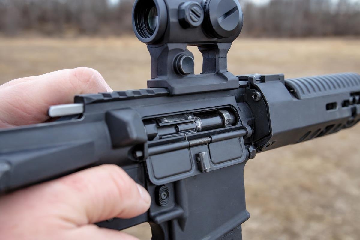 suppressed AR-15 charging handle gas management at receiver