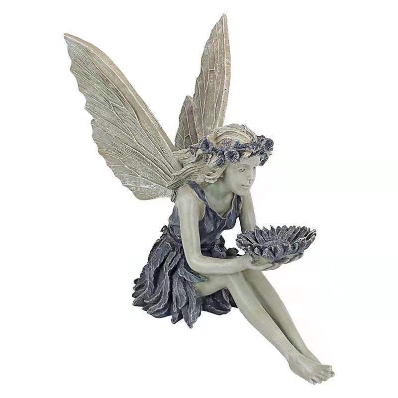 Decorative angel figurine as a birdbath for the garden