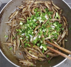 Bắc chảo bỏ 2 muỗng canh dầu ăn, tỏi, ớt, tiêu, hạt nêm, nước tương, nước mắm, đường đảo đều, bỏ cá đã chiên và đảo cho cá thấm nước sốt, bỏ hành vào, tắt bếp.