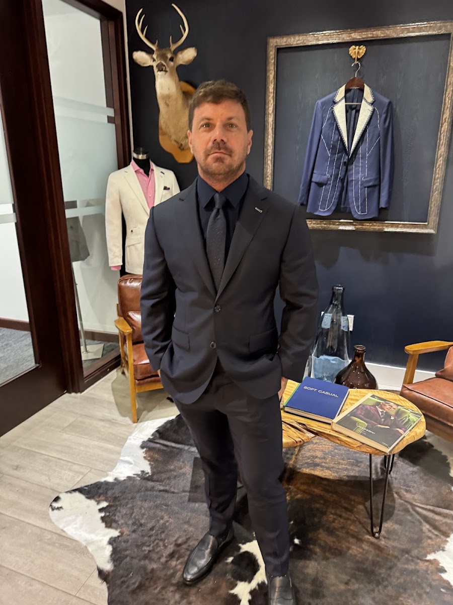 Navy bespoke suit with dark tie in the Bespoke By CB showroom — expert tailoring in Miami