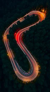 Aerial Night Shot of Serpentine Road with Car Light Trails