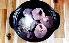 Pha loãng nước màu kho cá với 1.5 muỗng canh nước ấm. Xếp cá vào nồi đất (Cách làm cá lóc kho tiêu ngon là dùng nồi đất thay vì nồi kim loại). Thêm vào 2 muỗng cà phê hạt nêm, 1/2 muỗng cà phê muối, 1/2 muỗng cà phê bột ngọt, 2 muỗng cà phê đường, 1/2 muỗng cà phê tiêu, 3 muỗng canh nước mắm, nước màu đã pha và 2 trái ớt cắt nhỏ ướp cá trong nồi đất khoảng 10 phút.