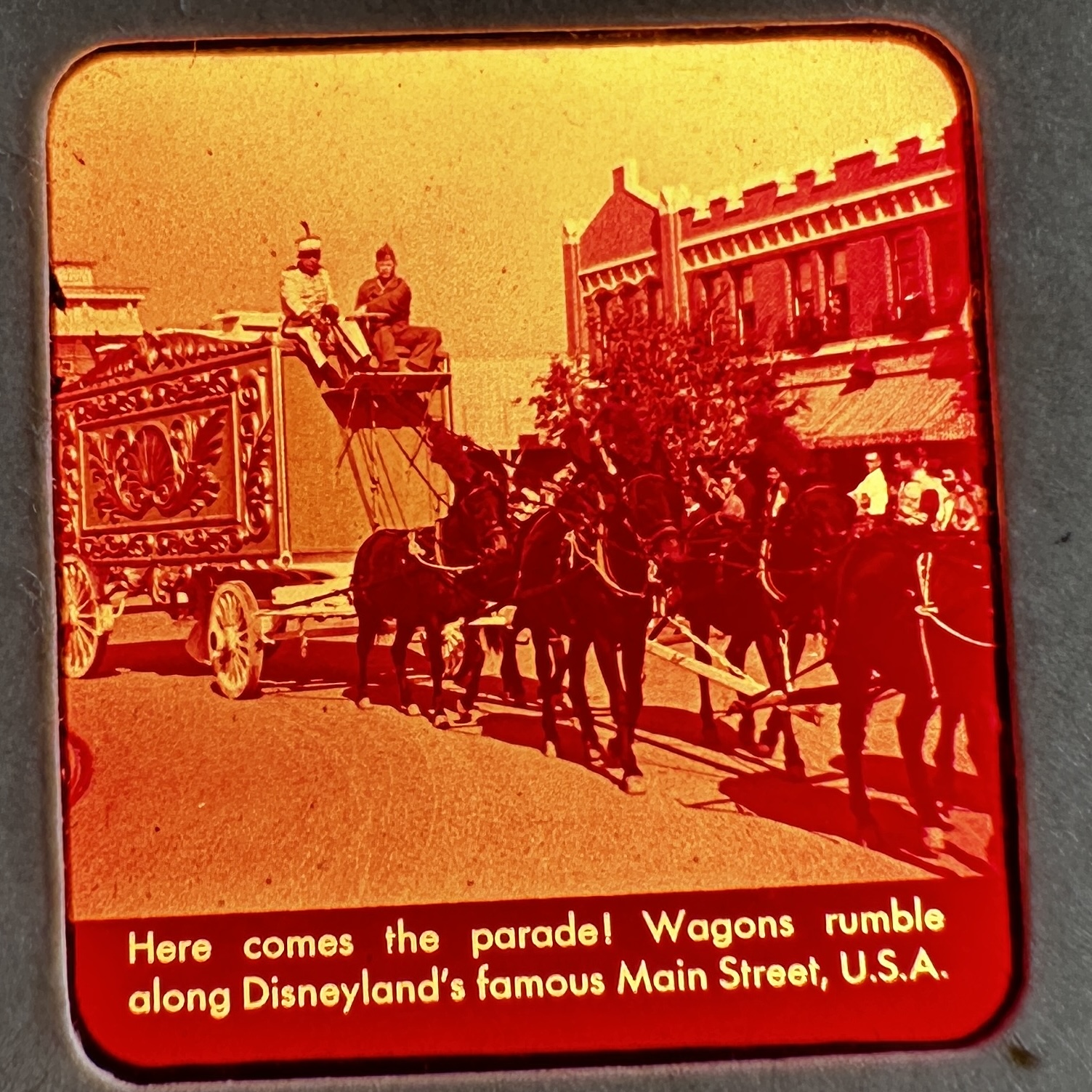 Sawyer's Inc. View-Master reel showing Mickey Mouse Club Circus wagons on Disneyland's Main Street U.S.A., circa 1955–1956, with visible magenta color shift on Kodachrome film