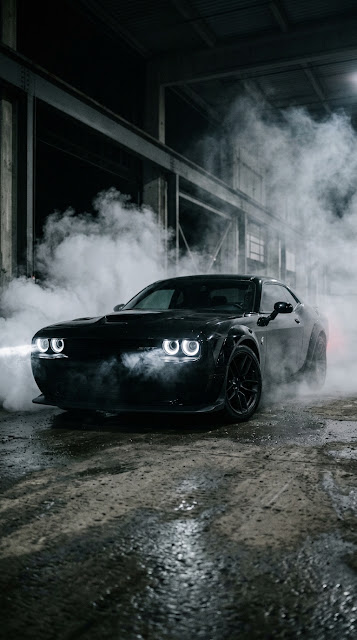 Black Muscle Car with Halo Headlights in Smoky Dark Environment - Free mobile Wallpaper