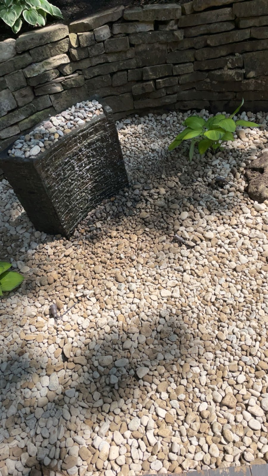 Custom stone retaining wall and patio combination in London, Ontario