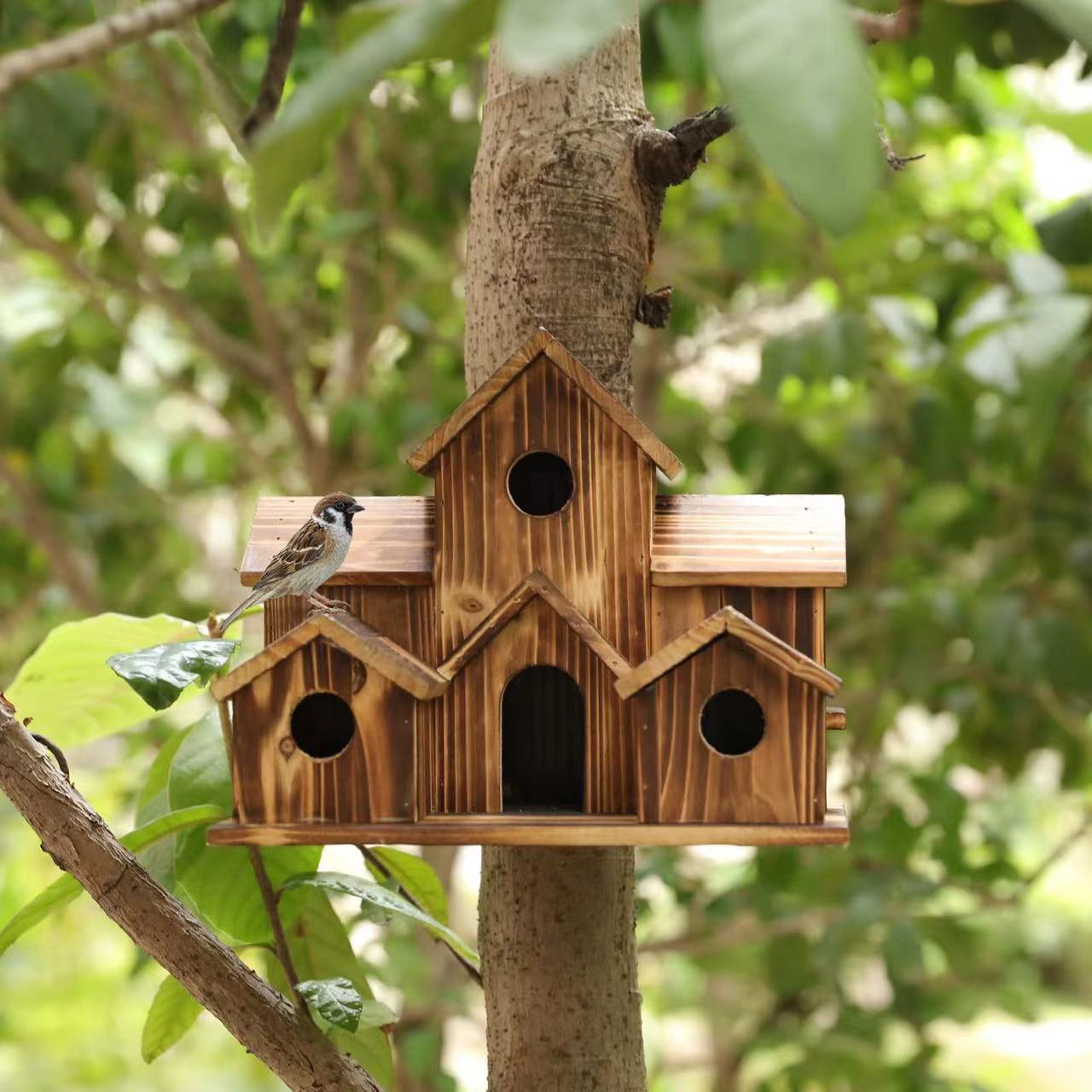 Wooden birdhouse in country house style for the garden