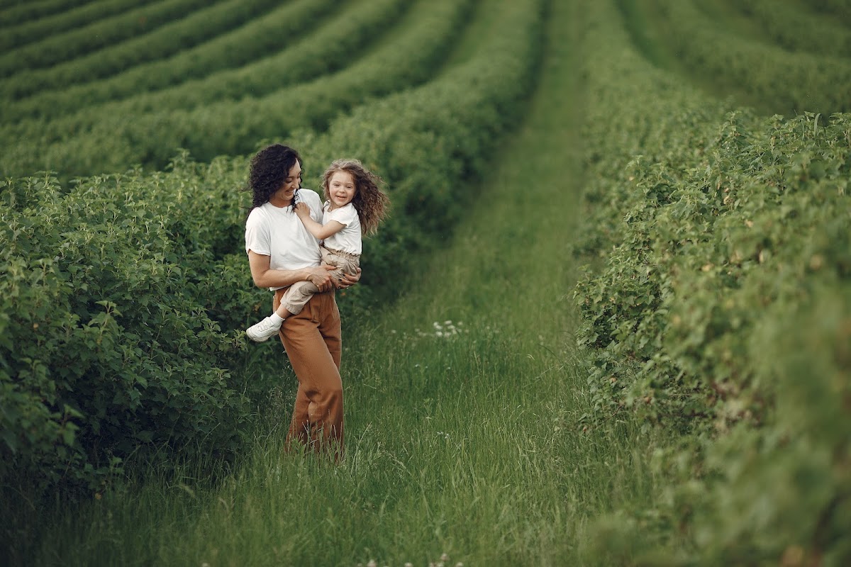 Mother and daughter in summer field
