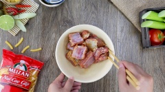 Cho 100gr thịt cua đã luộc chín, 100gr giò sống, 2 muỗng cà phê hạt nêm, 1 muỗng cà phê hành tím băm, 1 muỗng cà phê màu điều, 1/3 muỗng cà phê muối, 1/2 muỗng cà phê tiêu, 1 muỗng cà phê nước mắm vào chung một tô sạch. Phết đều cho chả hoà quyện và dai hơn. Trong một tô khác cho sườn heo cùng 1 muỗng cà phê nước mắm, 1 muỗng cà phê bột ngọt, 1/2 muỗng cà phê bột nghệ vào trộn đều, ướp 15 phút cho sườn heo thấm gia vị.