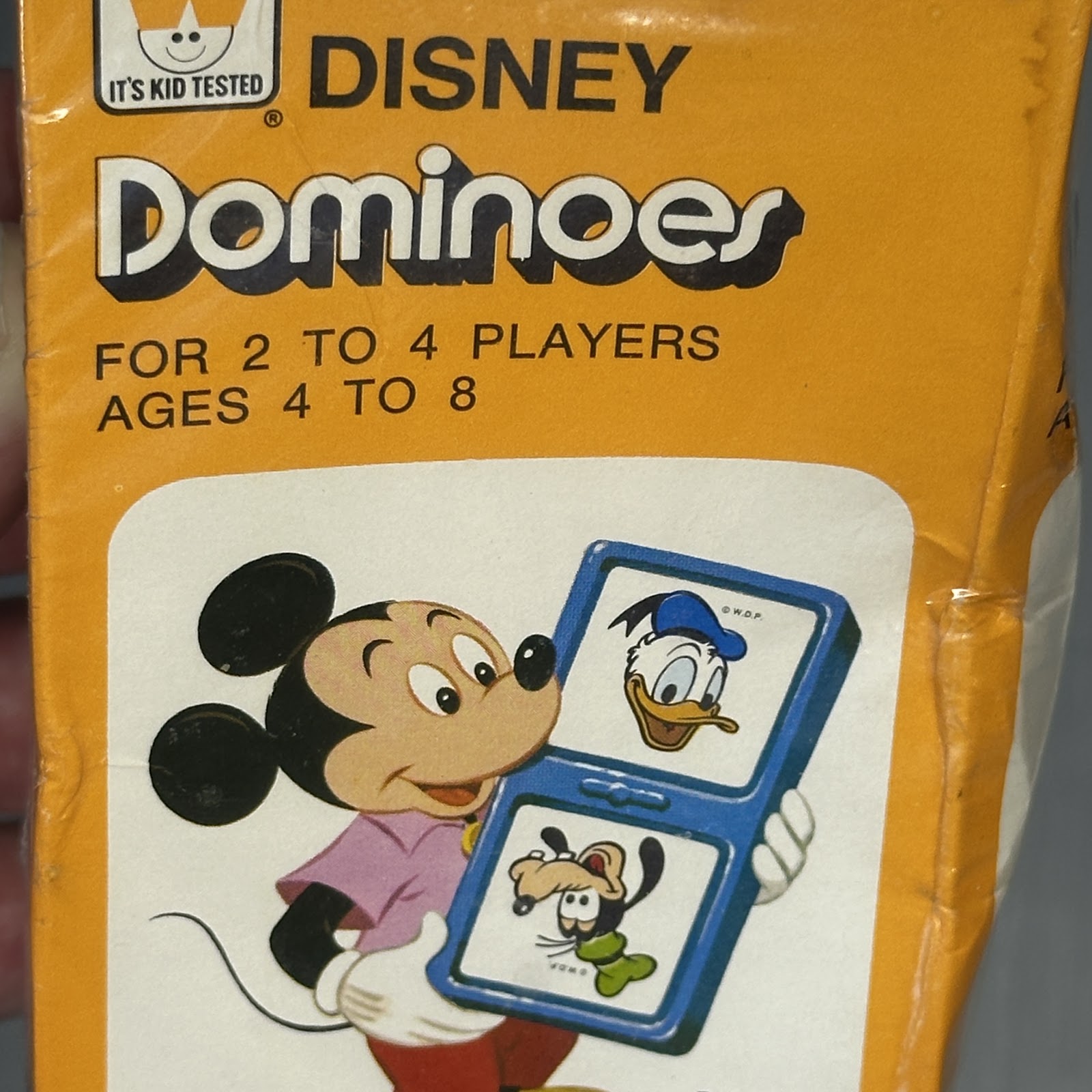 Walt Disney Dominoes by Whitman, mid-century box with Mickey Mouse, Donald Duck and Goofy and a blue domino graphic on a mustard-yellow background marked Kid Tested.