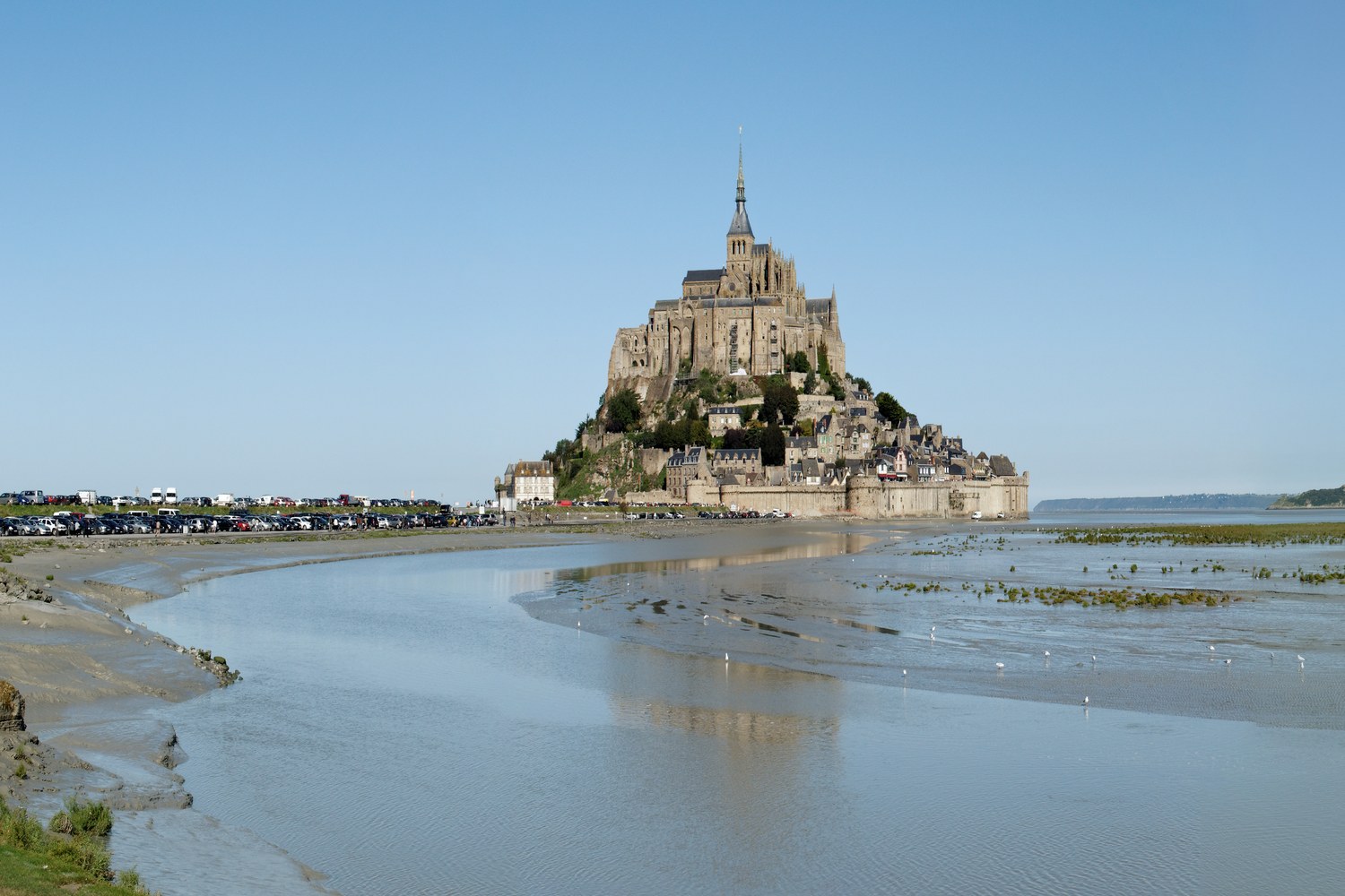 Mont Saint-Michel abbey rising above the tidal bay and mudflats in Normandy