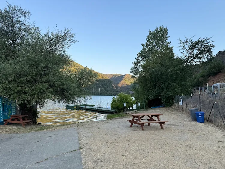 Lake beach with a picnic table and the dock on Upper Blue Lake