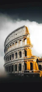 Dramatic Colosseum in Rome Under Dark Clouds and Mist