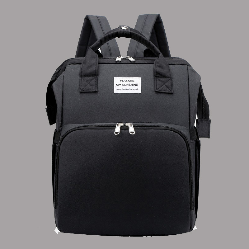 Diaper backpack with integrated changing pad