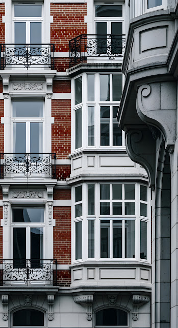 Close-up of Traditional Red Brick European Building with Ornate Balconies - Free mobile Wallpaper