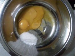 Trộn đều lòng đỏ trứng, 25g đường và dầu ăn trong tô bằng phới lồng. Thêm nước cốt chanh, sữa chua vào tô, trộn đều. Trộn đều bột mì và bột bắp rồi rây bột vào tô trứng.