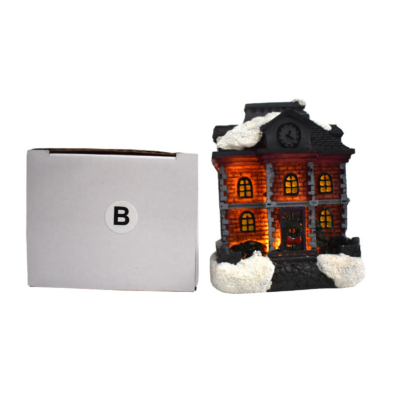 Illuminated Christmas House made of resin with snow effect