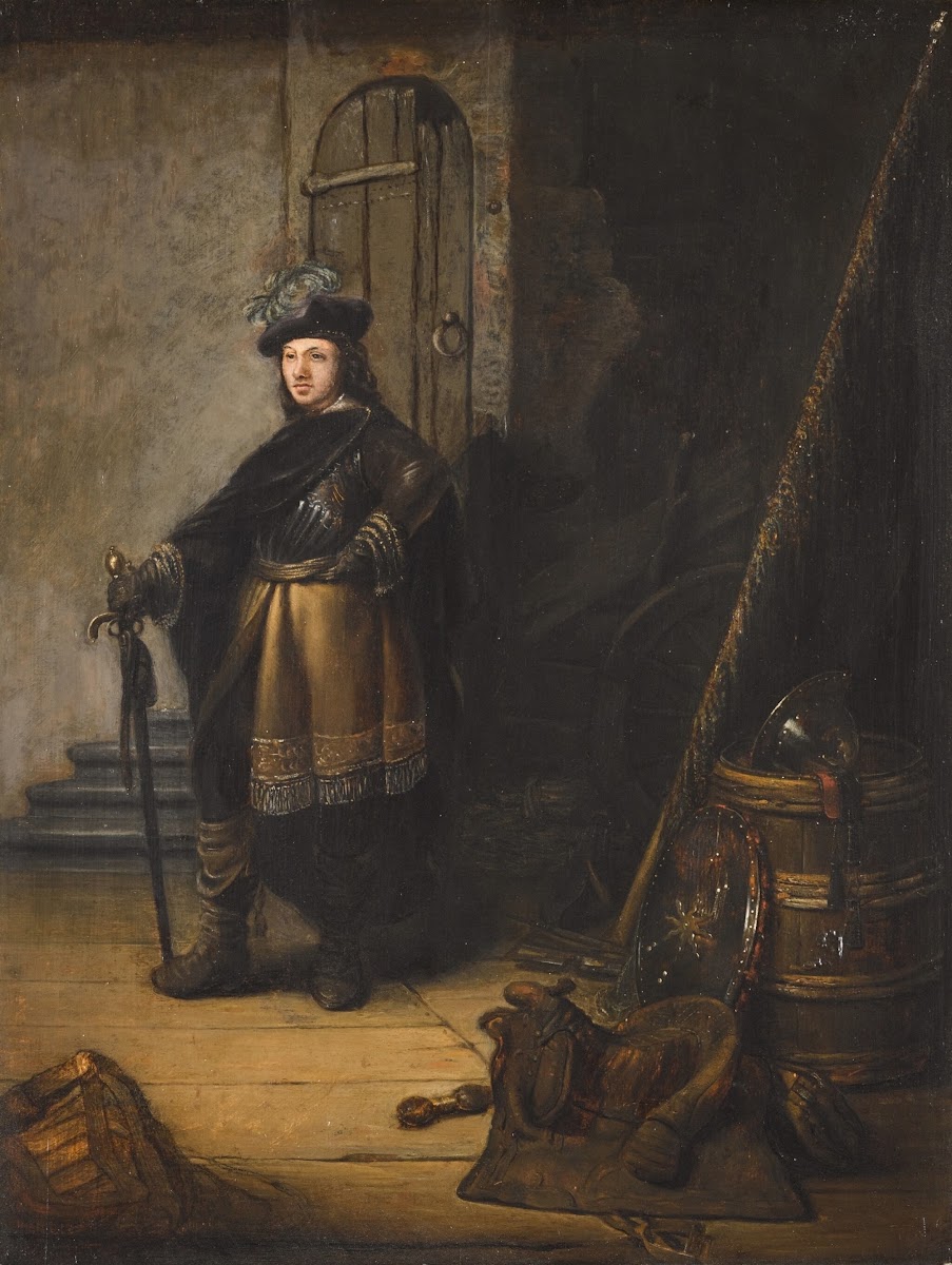 An officer standing in a guardroom before a doorway