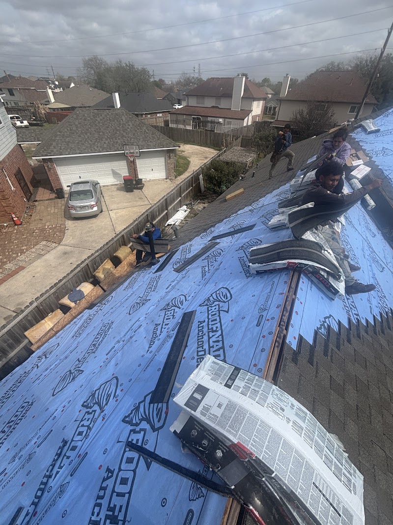 Crew re-roofing under a stormy sky