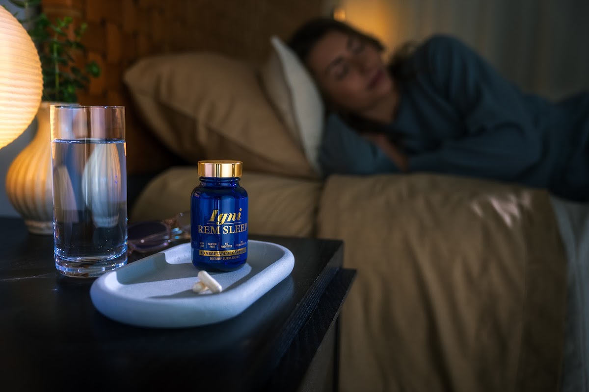 Woman asleep with IgniREM Sleep on the nightstand