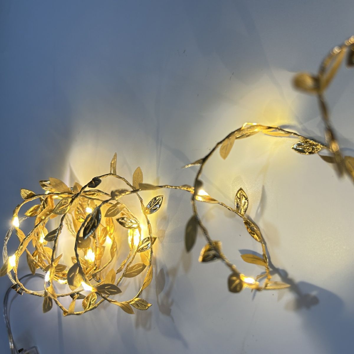 LED string lights with artificial leaves