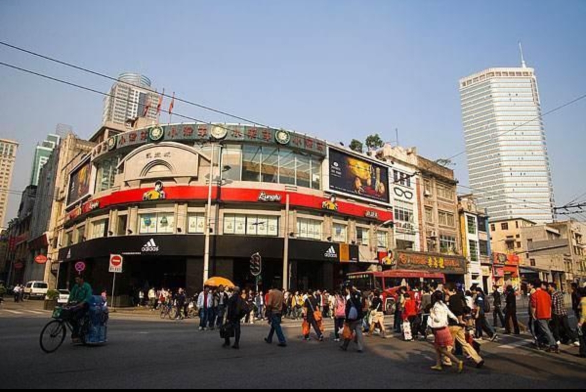 Shoppers trying on sneakers at a flagship sportswear store in Tianhe, Guangzhou