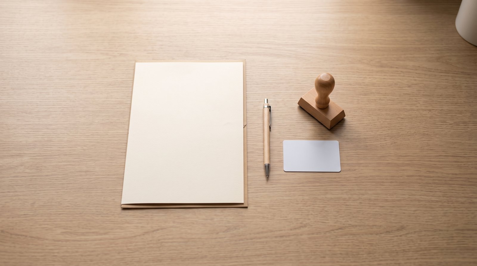 A document folder, pen and notary stamp on a desk