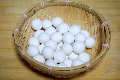 Cho bột gạo nếp vào âu, thêm nước sôi vào rồi dùng đũa trộn đều bột, nhào bột thành khối mềm mịn. Viên bột thành từng viên tròn nhỏ.