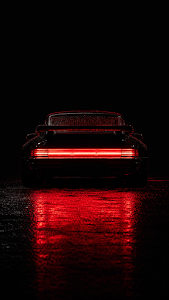 1980s Retro Black Sports Car Tail Lights in the Rain