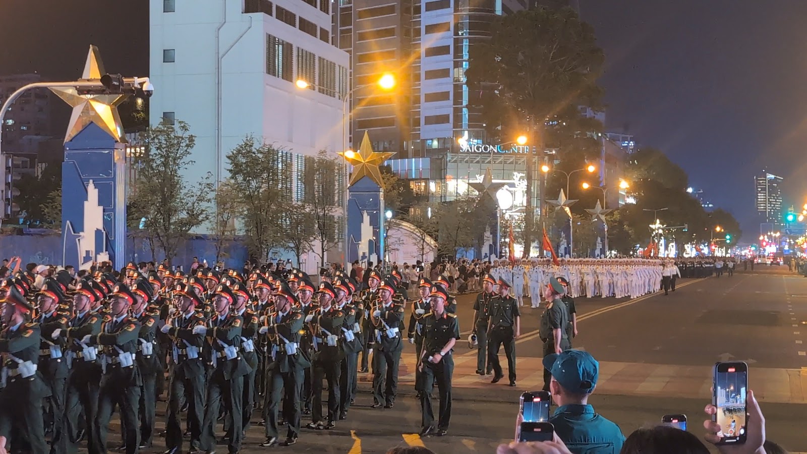 Photo from the parade rehearsal with many soldiers in uniform marching
                 on the street
