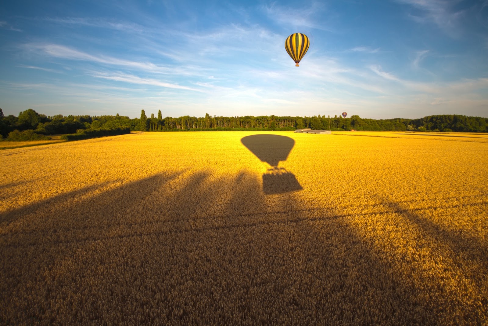 Hot-air balloon floating above the green countryside and historic landscape of France’s Loire Valley.