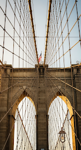 Extreme Low Angle View Upwards at Brooklyn Bridge Stone Arches and Suspension Cables
