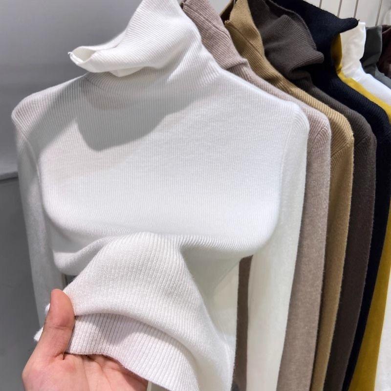 Slimming women's knitted sweater with a high collar