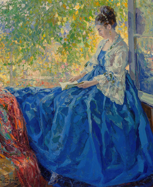 Young woman reading at an open window