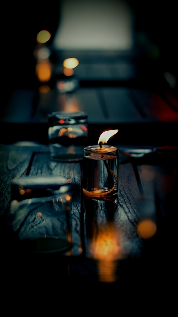 Single Candle Glowing on Dark Wooden Table - Free mobile Wallpaper