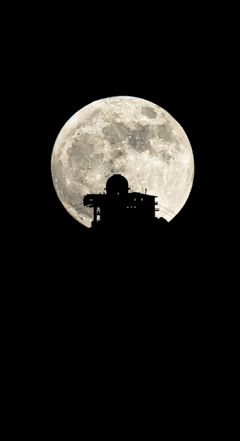High-Contrast Silhouette of Alpine Summit Structure Against a Giant Full Moon - Free mobile Wallpaper