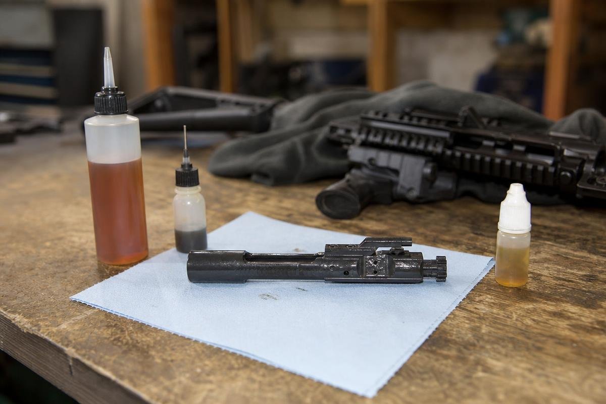 Bolt carrier group being prepared for routine lubrication