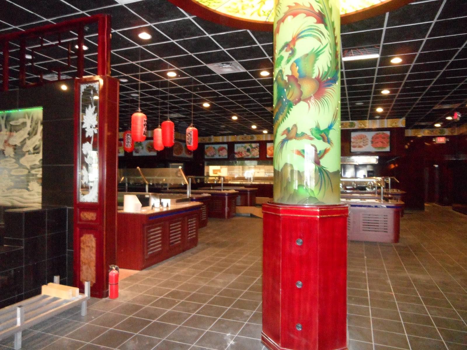 Buffet area featuring a red pillar with bird illustrations, red buffet counters with sneeze guards, and hanging red lanterns.