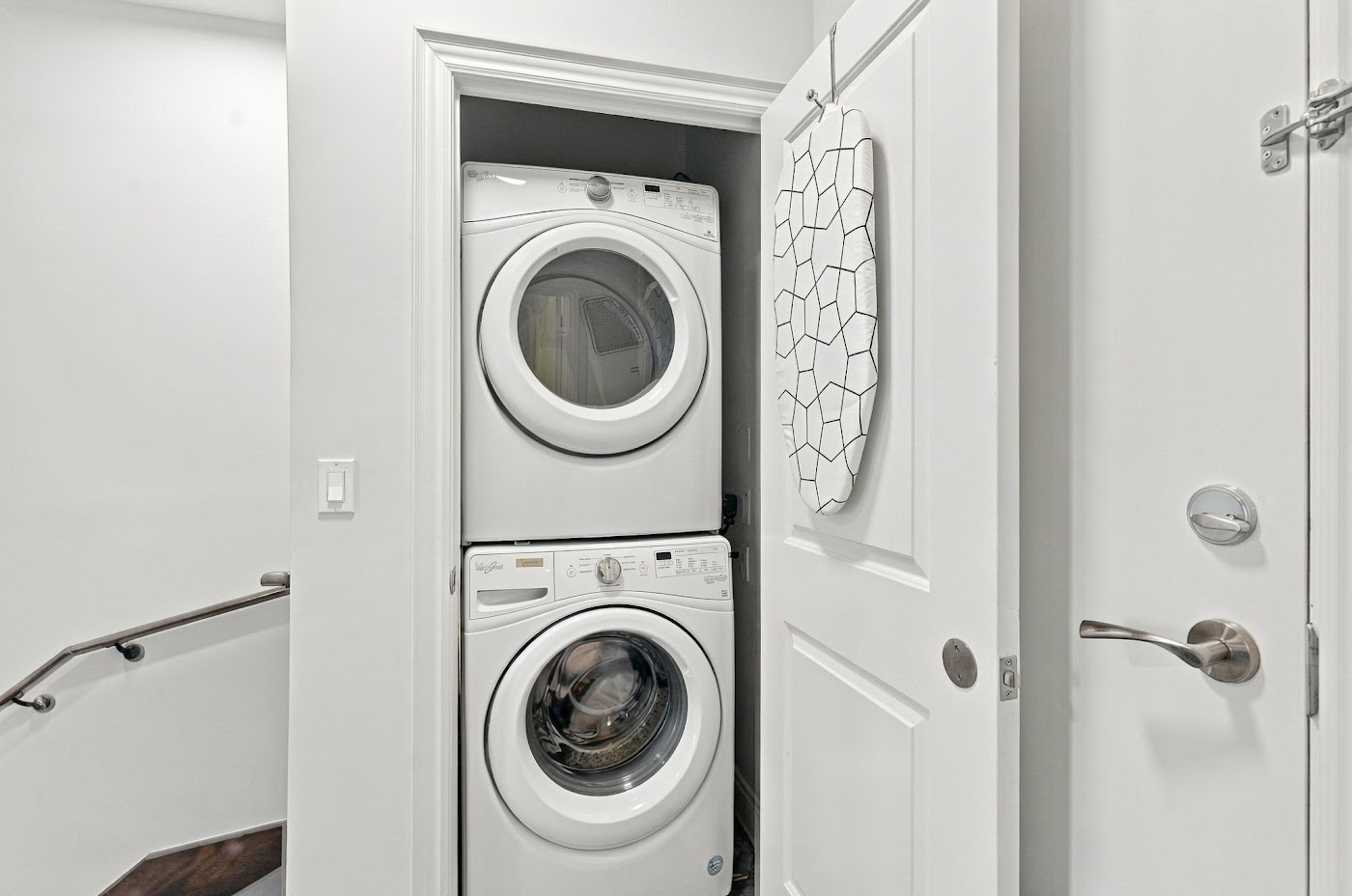 Stacked stainless steel washer and dryer in the laundry closet