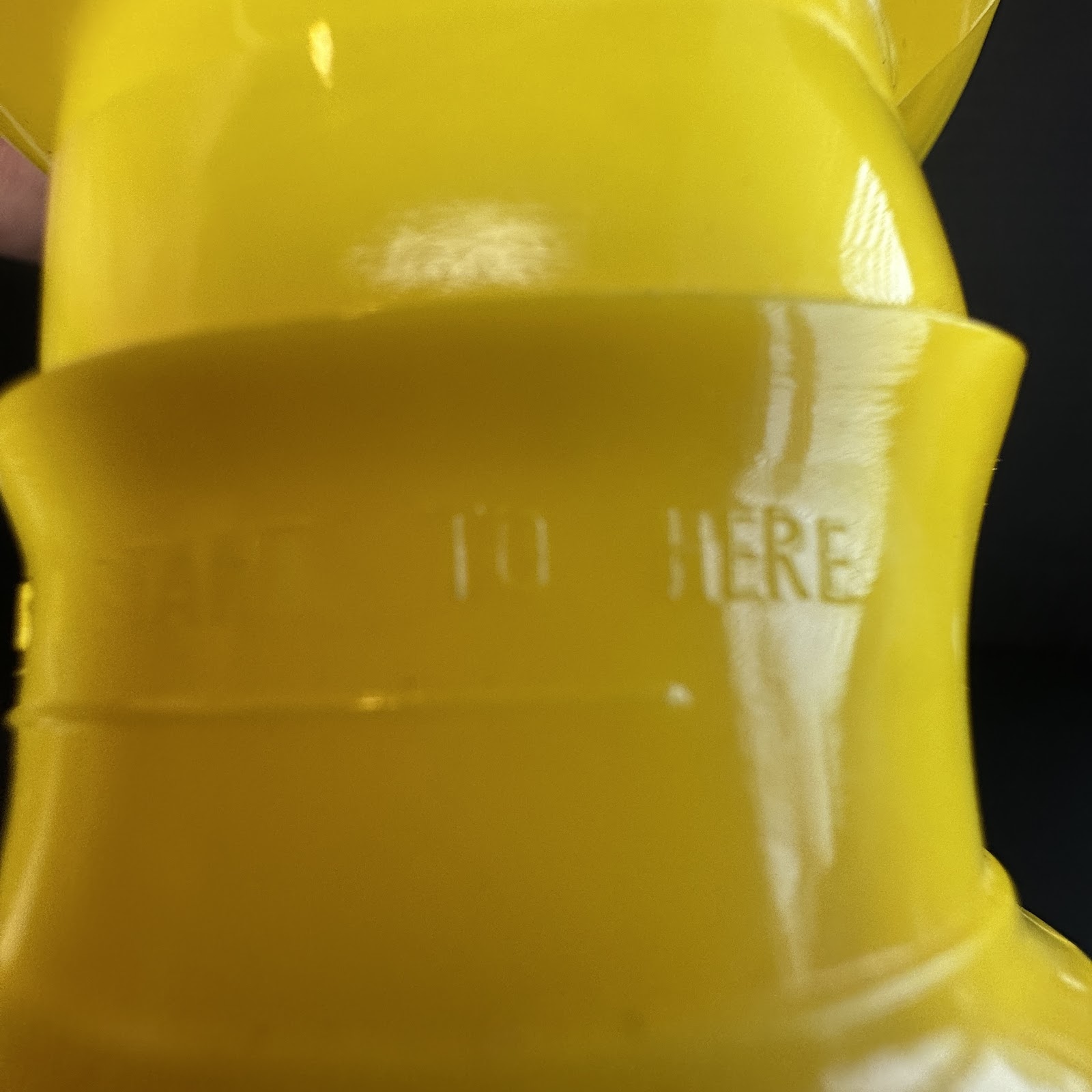 Vintage yellow HDPE blow-molded Disney container component with raised "FILL TO HERE" text, likely Pluto or Winnie the Pooh, circa late 1960s–early 1970s