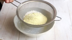 Chuẩn bị phần bột thứ 2 của vỏ bánh bao nhân thịt: rây bột mì, sữa bột, đường bột và bột nở vào 1 tô chung với nhau. Dùng phới lồng trộn thật đều các nguyên liệu.