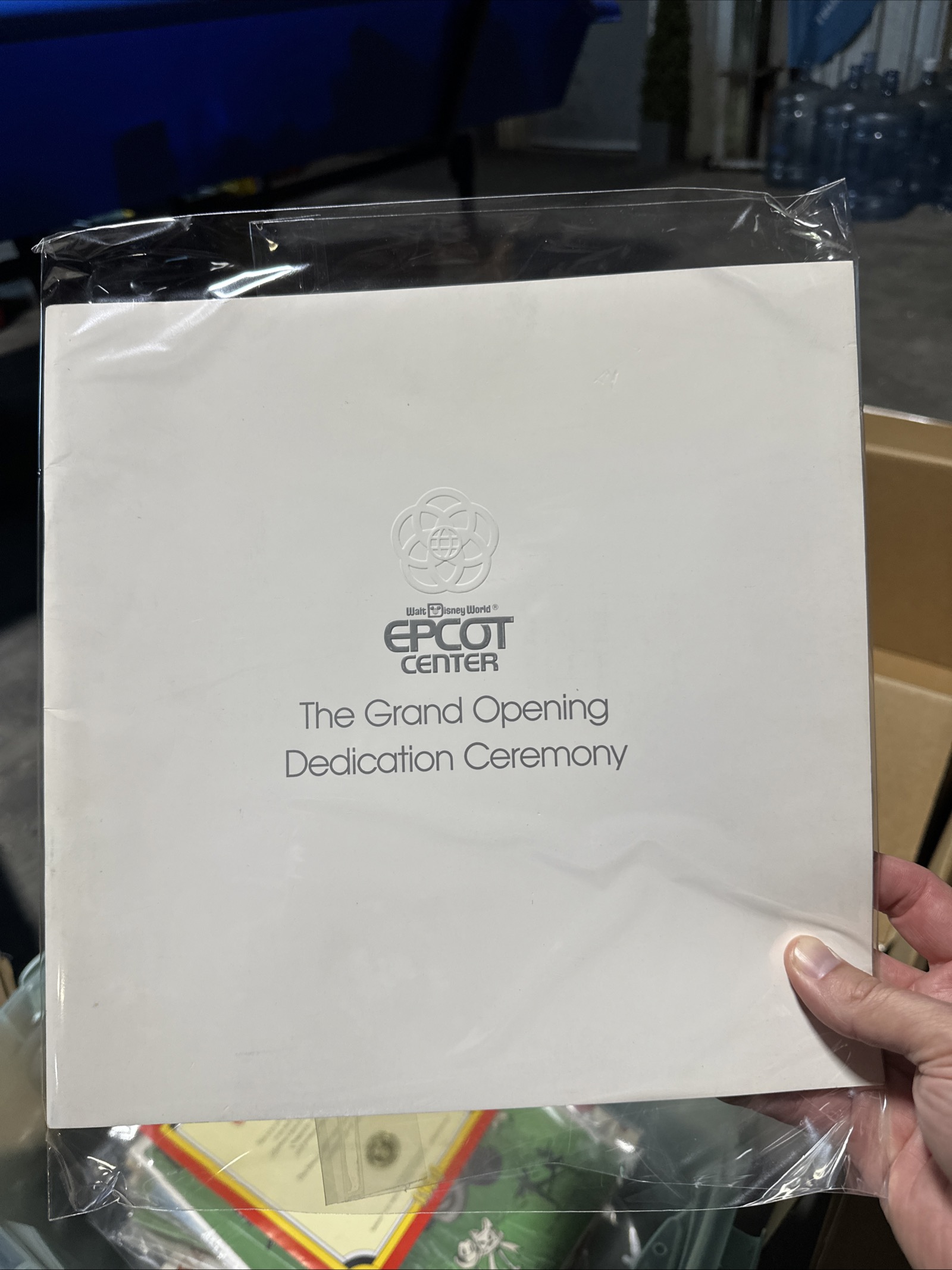 Tokyo Disneyland Grand Opening 1983 dedication ceremony program, large-format black textured cardstock cover with blind-embossed logo and silver foil-stamped Mickey D logo and date